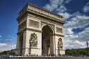 The Arc de Triomphe under a blue sky with white clouds