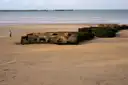Concrete remains of the Mulberry harbour on the beach at Arromanches