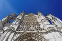 The tall Gothic facade of Beauvais cathedral against a blue sky