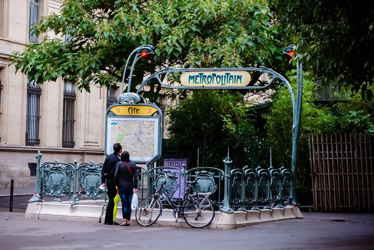 An Art Nouveau Paris metro entrance with green railings