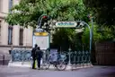 An Art Nouveau Paris metro entrance with green railings