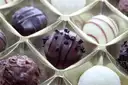 Chocolate pralines and truffles in a clear tray