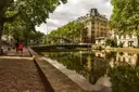 Canal Saint-Martin with trees and buildings reflected in the still water
