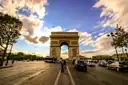 The Champs-Élysées leading to the Arc de Triomphe under a dramatic sky