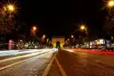 The Champs-Élysées at night with light trails leading to the Arc de Triomphe