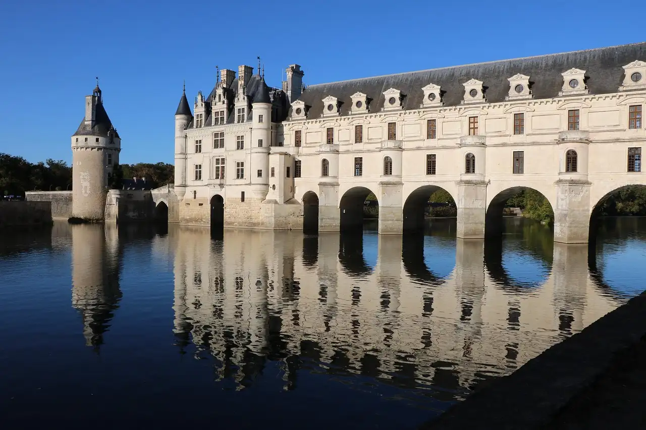 The Château de Chenonceau's arched gallery spanning the river Cher, reflected in the water