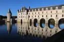The Château de Chenonceau's arched gallery spanning the river Cher, reflected in the water