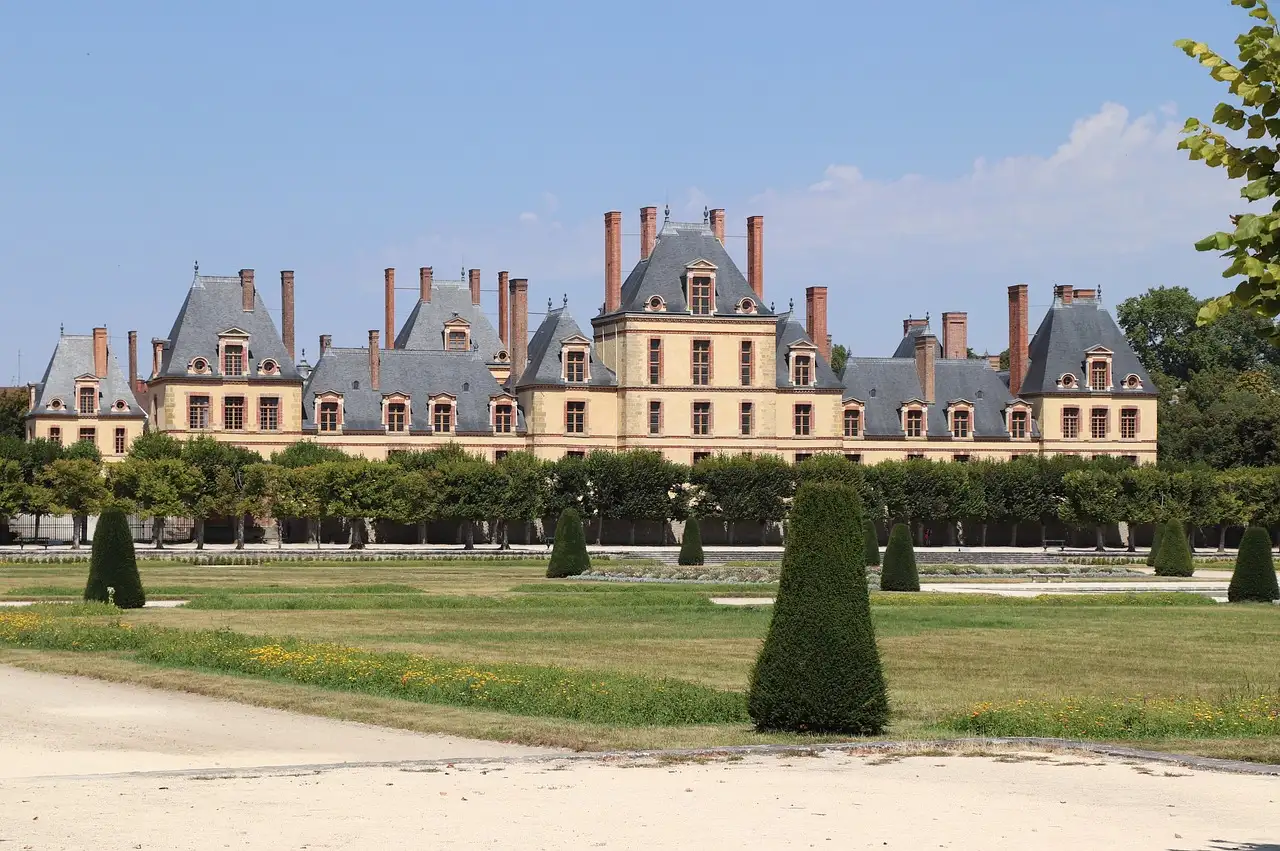 The Château de Fontainebleau seen across its lawns and clipped yews