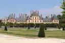 The Château de Fontainebleau seen across its lawns and clipped yews
