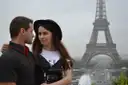 A couple posing at the Trocadéro, the Eiffel Tower behind them