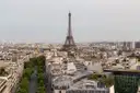 The Eiffel Tower above Paris rooftops seen from the Arc de Triomphe