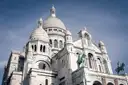 The white domes and stone facade of the Sacré-Cœur basilica in Montmartre