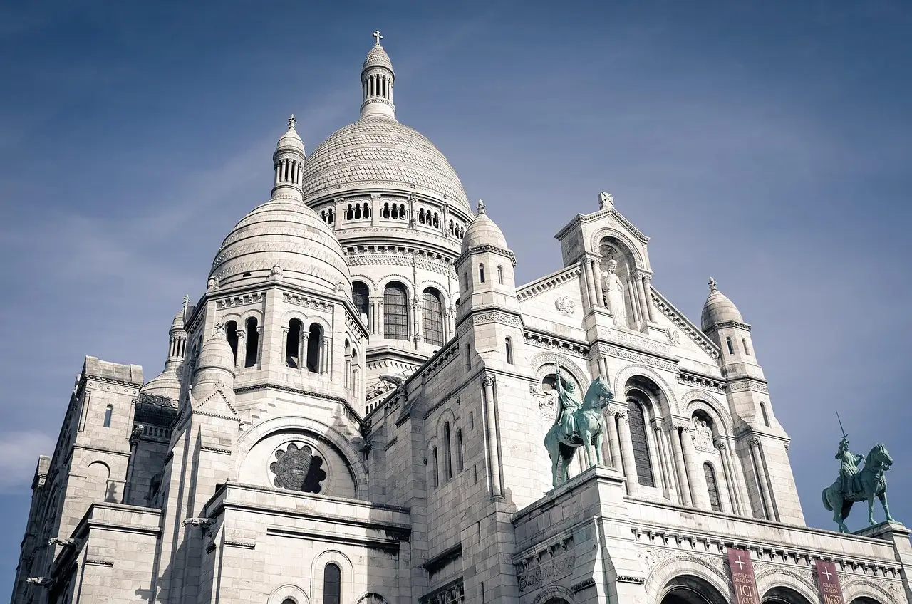 The white domes and stone facade of the Sacré-Cœur basilica in Montmartre