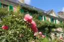 Pink roses in front of Monet's house with its green shutters at Giverny