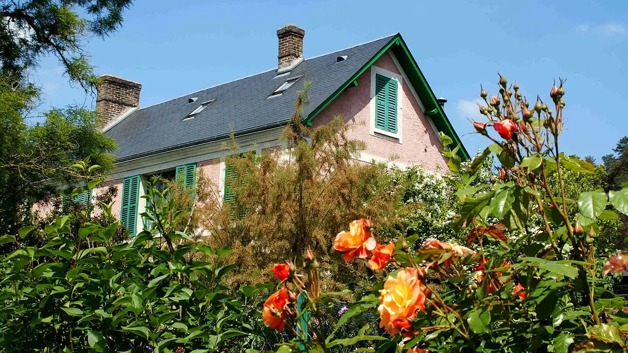 Monet's house at Giverny behind orange roses