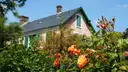 Monet's house at Giverny behind orange roses