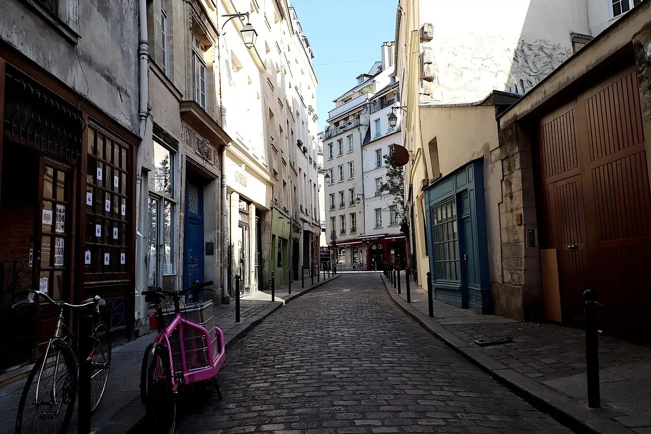 A narrow cobbled street in the Latin Quarter with bicycles parked by the wall