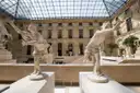 Marble sculptures under the glass roof of the Cour Marly in the Louvre
