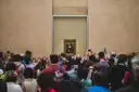 Visitors crowding in front of the Mona Lisa in the Louvre