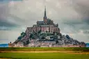 Mont-Saint-Michel rising above green meadows