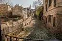 A curving cobbled Montmartre street climbing toward the Sacré-Cœur
