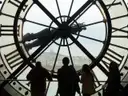 Visitors in silhouette behind the Musée d'Orsay's giant clock-face window