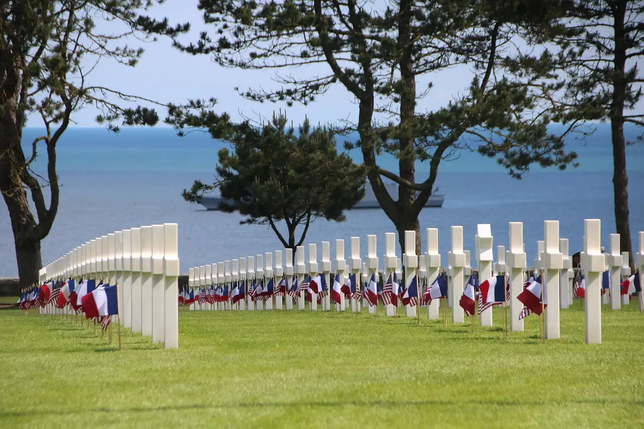 White crosses in rows at the Normandy American Cemetery above the sea