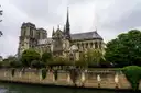 Notre-Dame Cathedral above the stone wall of the Seine embankment