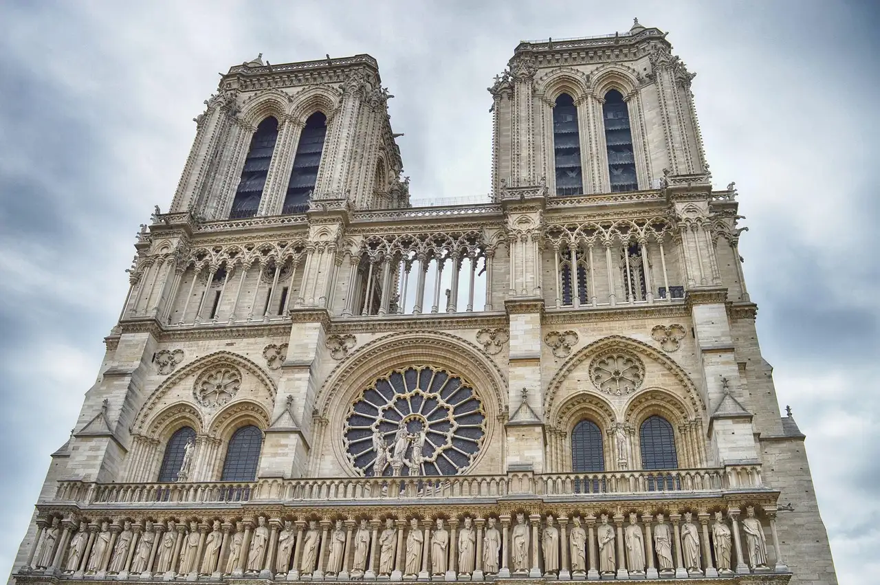 The carved west front and rose window of Notre-Dame seen from below