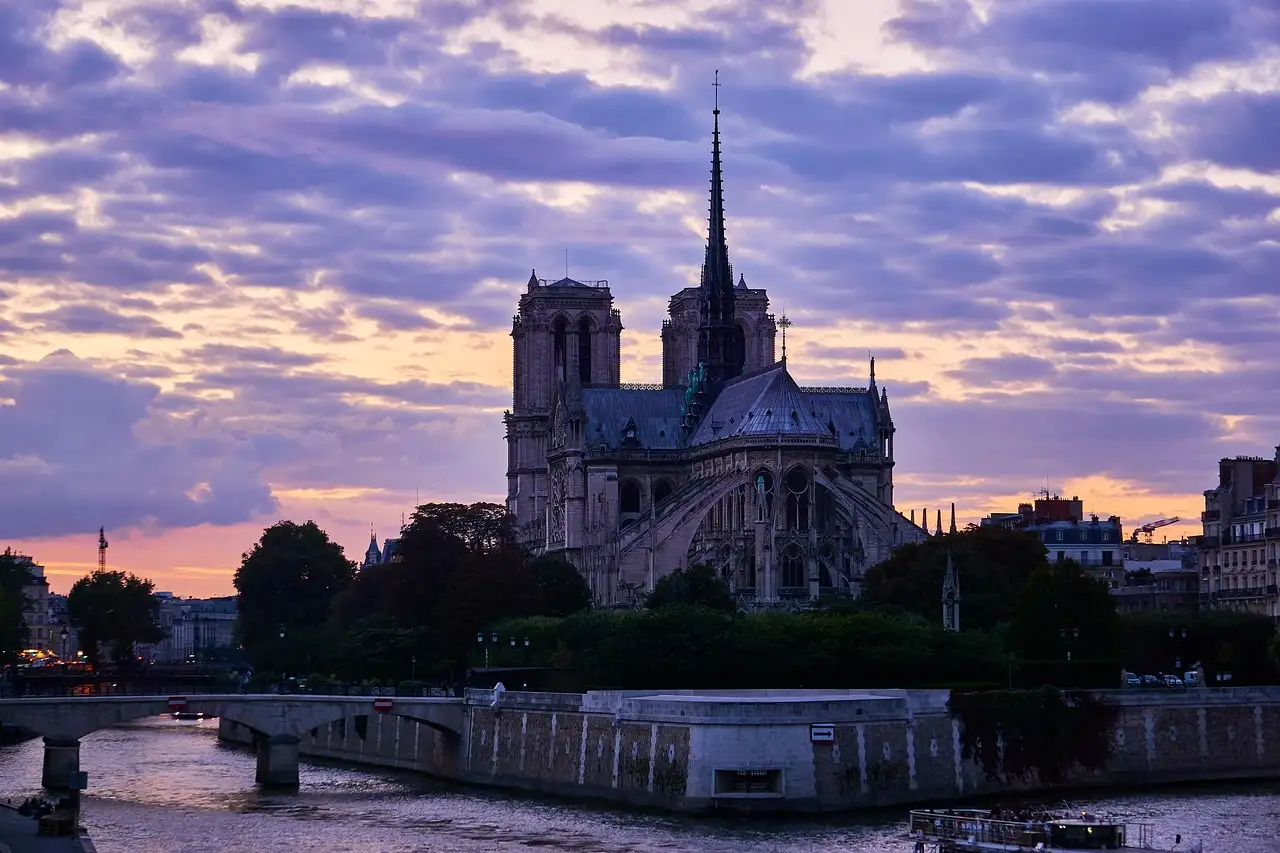 Notre-Dame in silhouette above the Seine at sunset