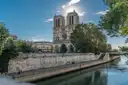 The towers of Notre-Dame above the trees and the Seine embankment