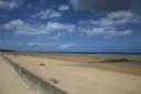 The wide sandy shore of Omaha Beach in Normandy on a clear day