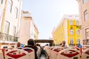 Passengers on the open top deck of a sightseeing bus