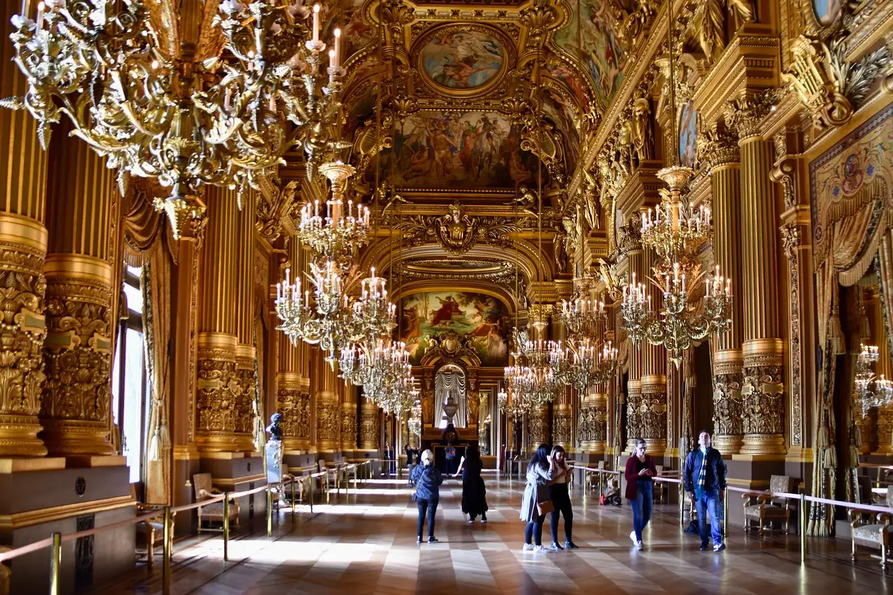 The gilded Grand Foyer of the Palais Garnier with its chandeliers