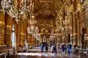 The gilded Grand Foyer of the Palais Garnier with its chandeliers