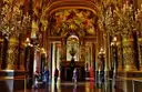 A gilded salon in the Palais Garnier with chandeliers
