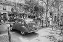 A Citroën 2CV parked on a Paris street, in black and white