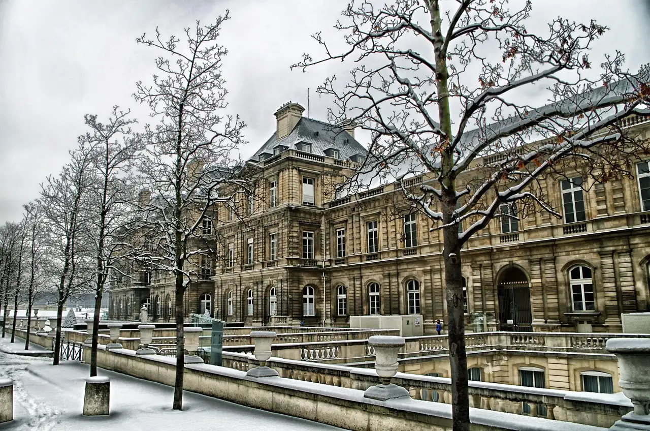 The Luxembourg Palace in Paris with snow on the trees and terrace walls