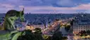 A Notre-Dame gargoyle looking out over Paris rooftops and the Seine toward the Eiffel Tower at dusk