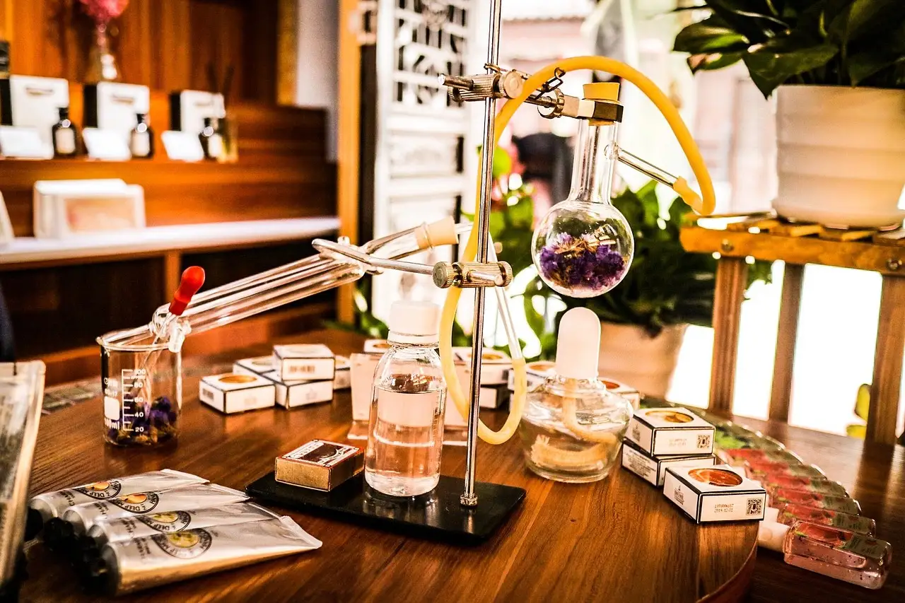 A perfume-making bench with glass flasks, tubes and small bottles