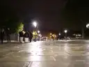 A Paris pavement glistening under street lamps at night