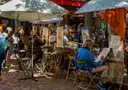 Painters at their easels under umbrellas on the Place du Tertre in Montmartre