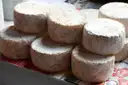 Small rounds of aged French cheese stacked together
