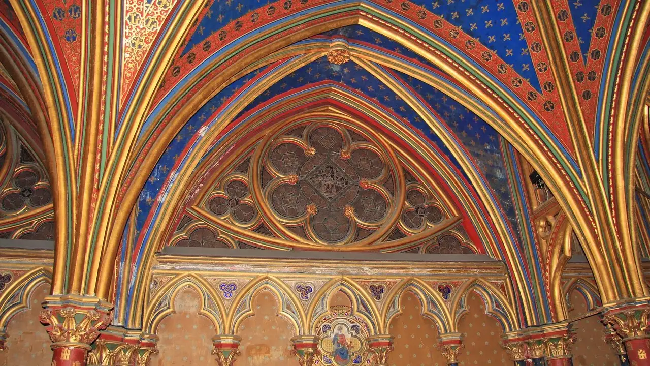 Gilded arches and a carved rose under the starry blue vault of the Sainte-Chapelle lower chapel