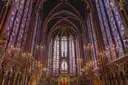 The nave of Sainte-Chapelle with tall stained-glass windows