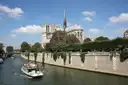 A river boat on the Seine passing below Notre-Dame cathedral