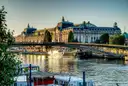 The Seine in evening light with a footbridge and the Musée d'Orsay on the far bank