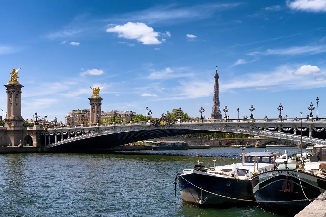 The Pont Alexandre III and moored boats on the Seine, the Eiffel Tower in the distance