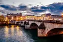 The Pont Neuf and the lit Louvre riverfront at dusk