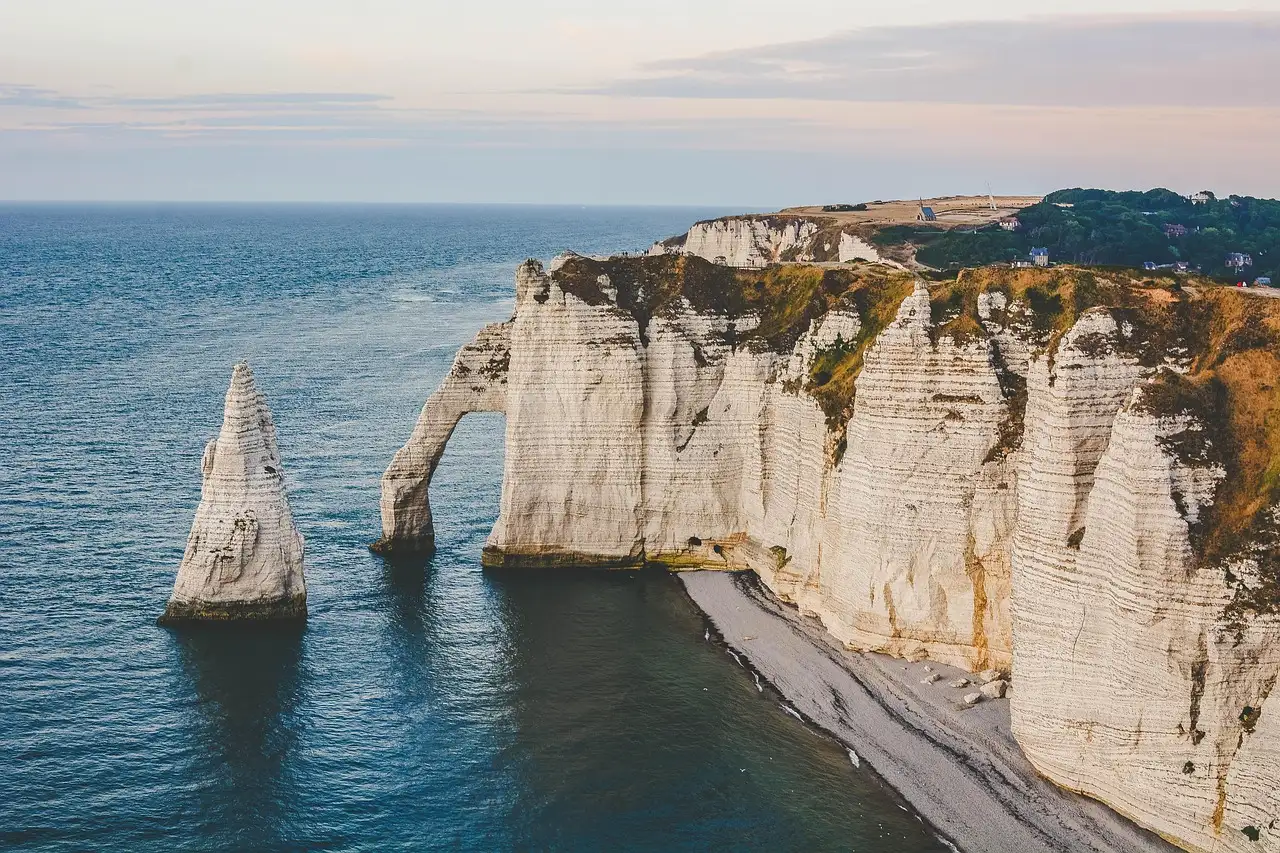 White chalk cliffs and sea arches at Etretat on the Normandy coast at golden hour